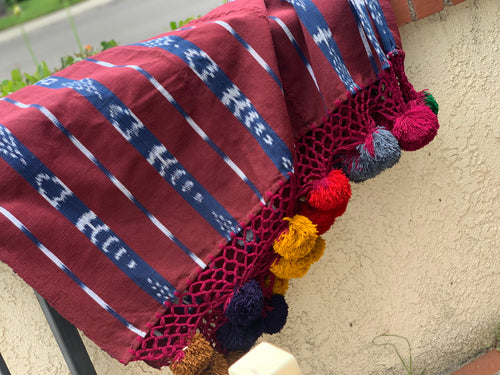 Foot loomed blanket with pom poms